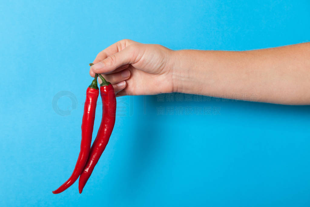 Red color chilli pepper in hand, heat asian food.