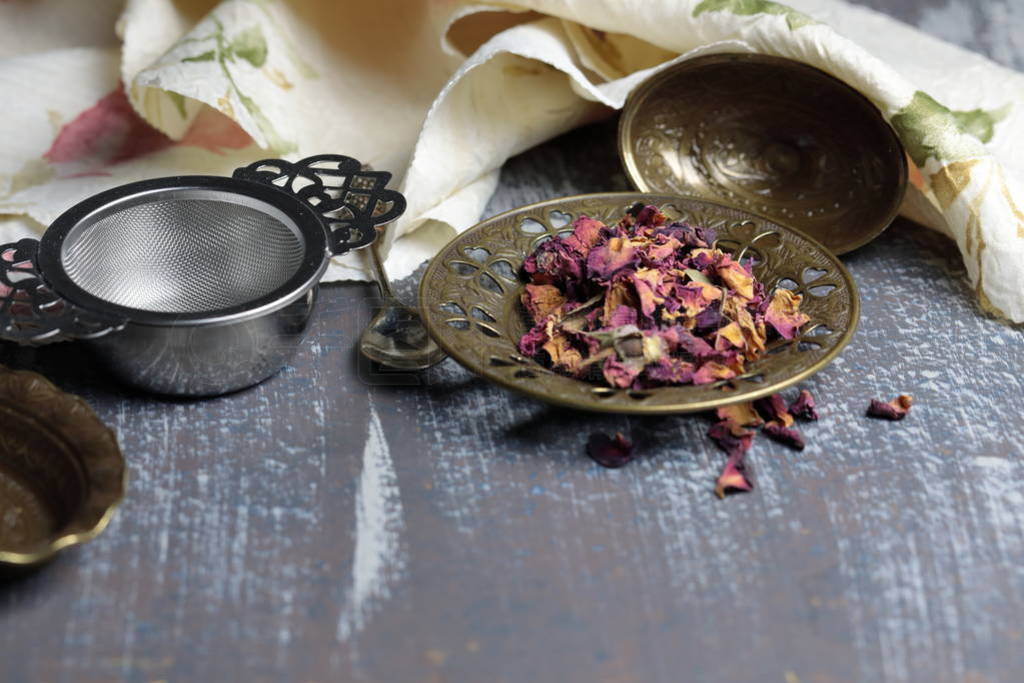 Dried Rose petals for making Rose tea in a metal container on a