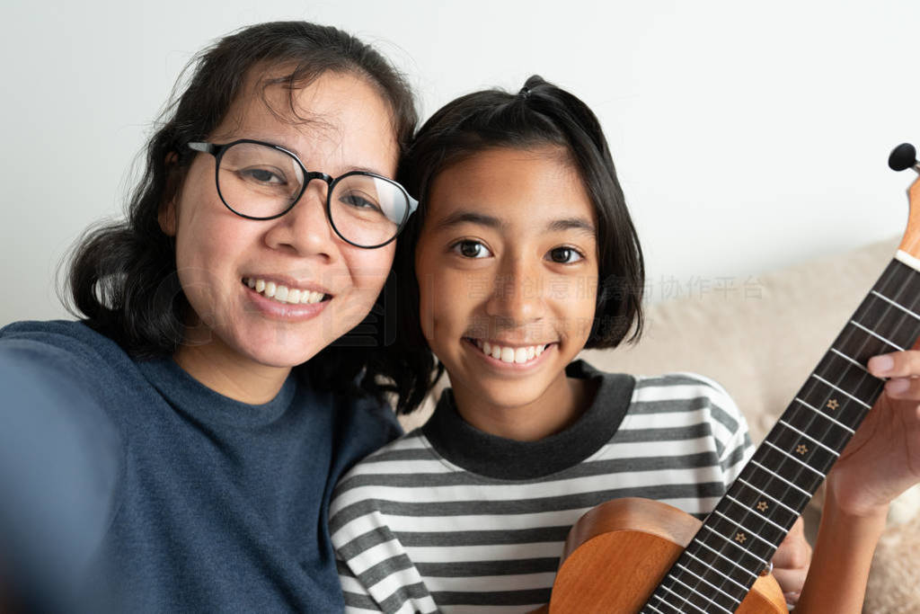 Close-up of an Asian mother and daughter taking a selfie and s