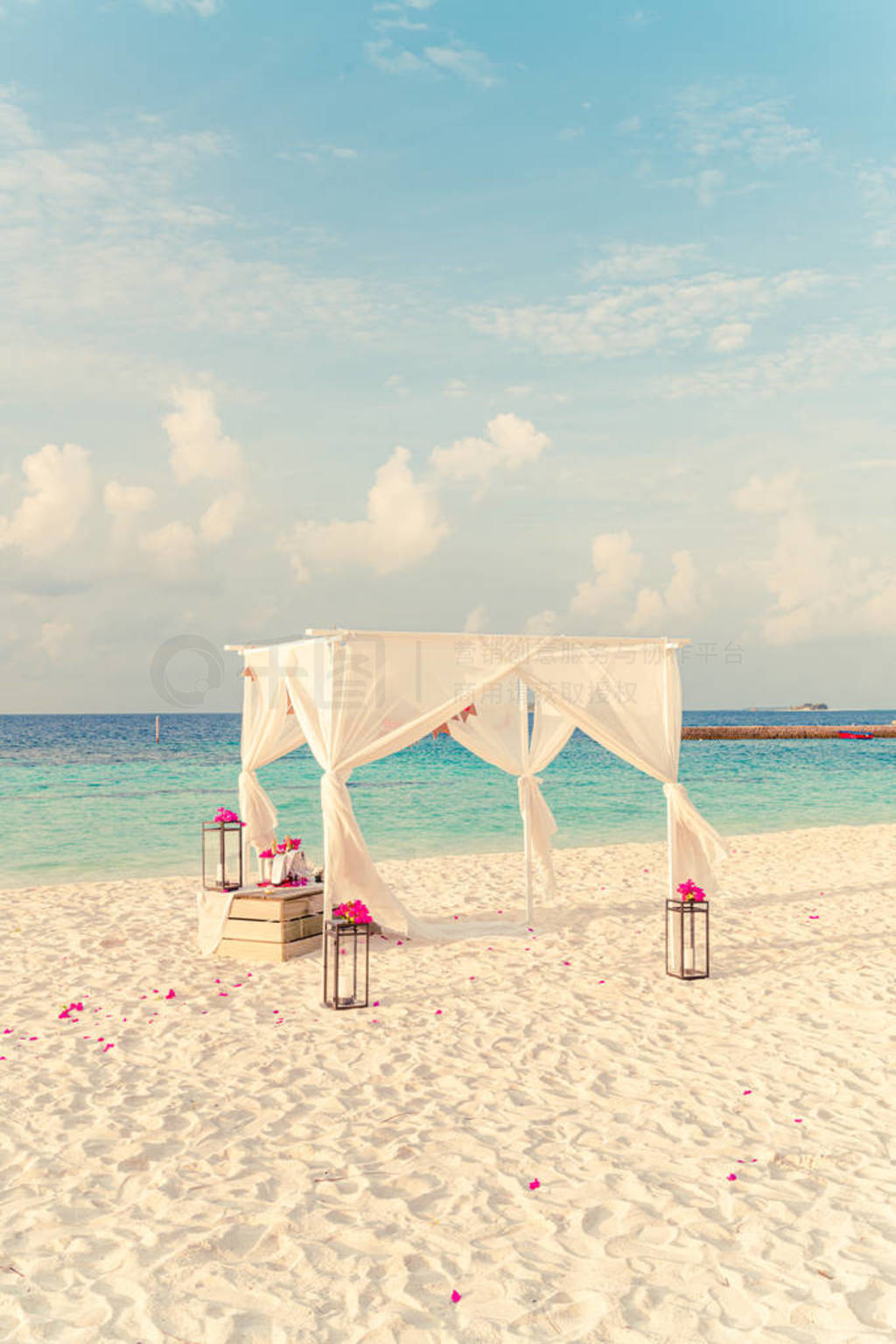 wedding arch on beach with tropical Maldives resort and sea