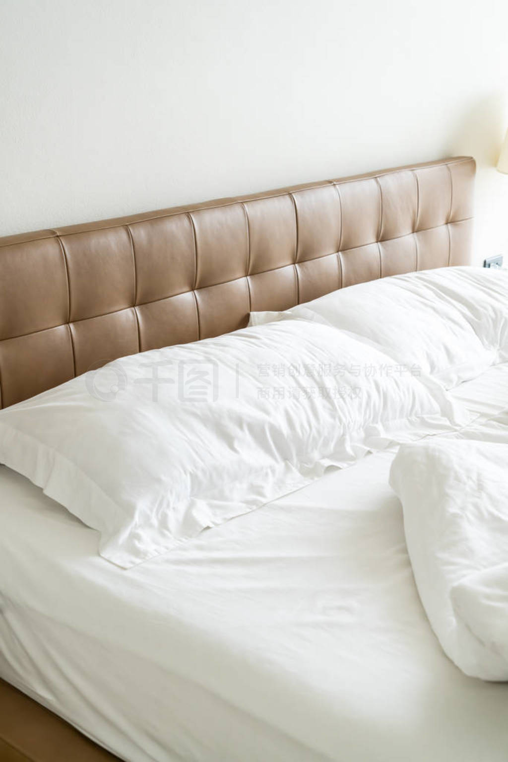 Messy bed with white pillow and blanket on bed