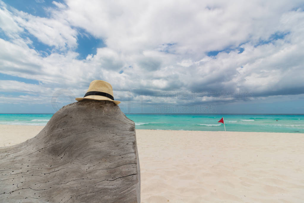 Crystal clear sea with white sand and cloud sky.