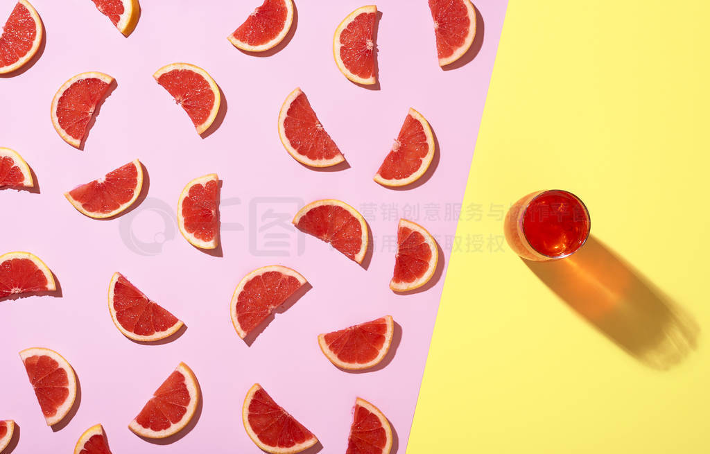 Grapefruit cold drink and grapefruit slices in sunlight. Summer