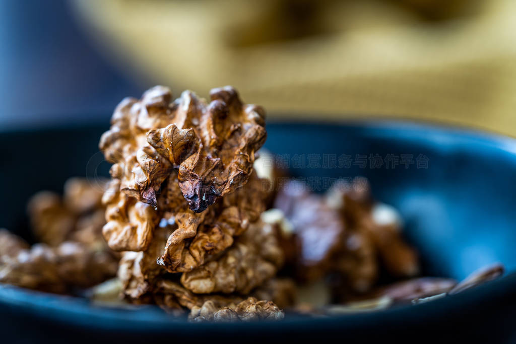 Walnut Kernels and Whole walnuts in Porcelain Bowl.