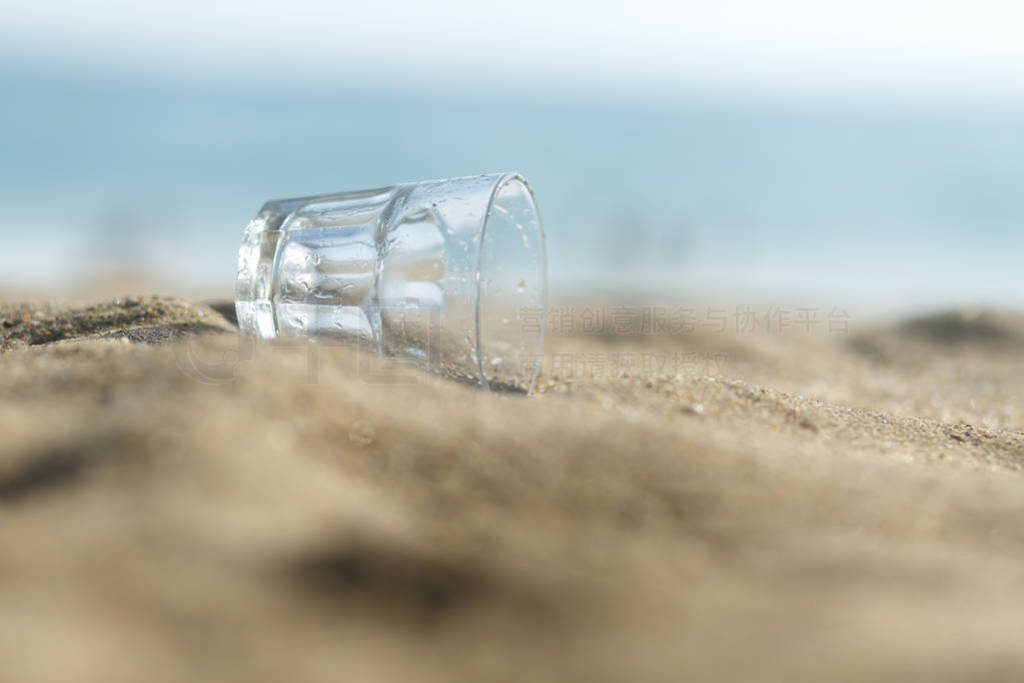 Empty glass Cup on sand