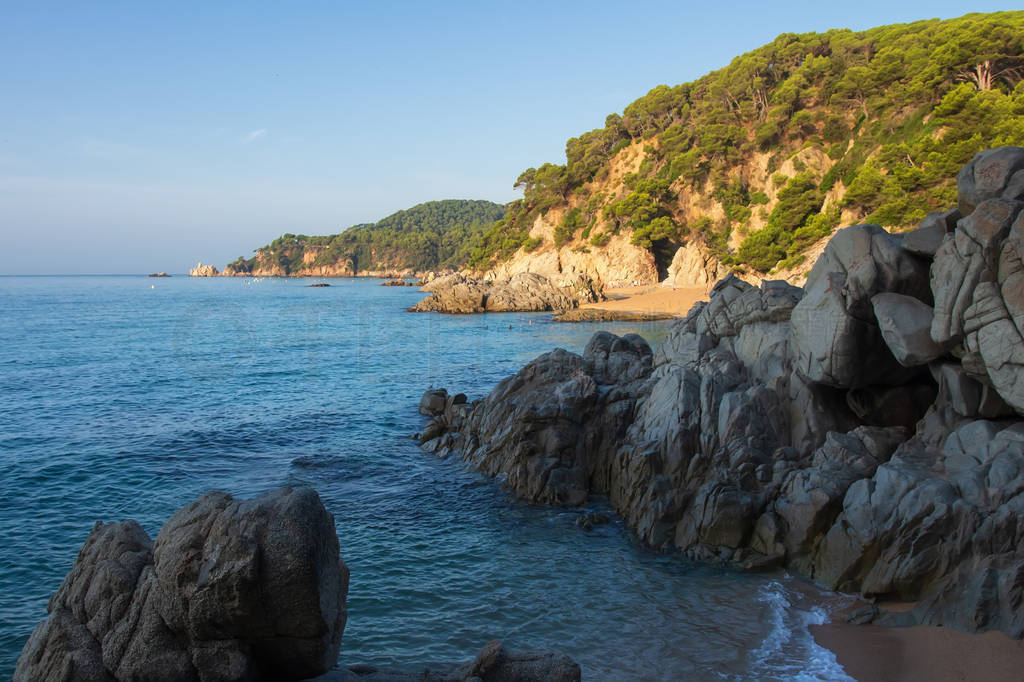 Spain beach in Lloret de Mar. Cala de Boadella platja. Rocks on