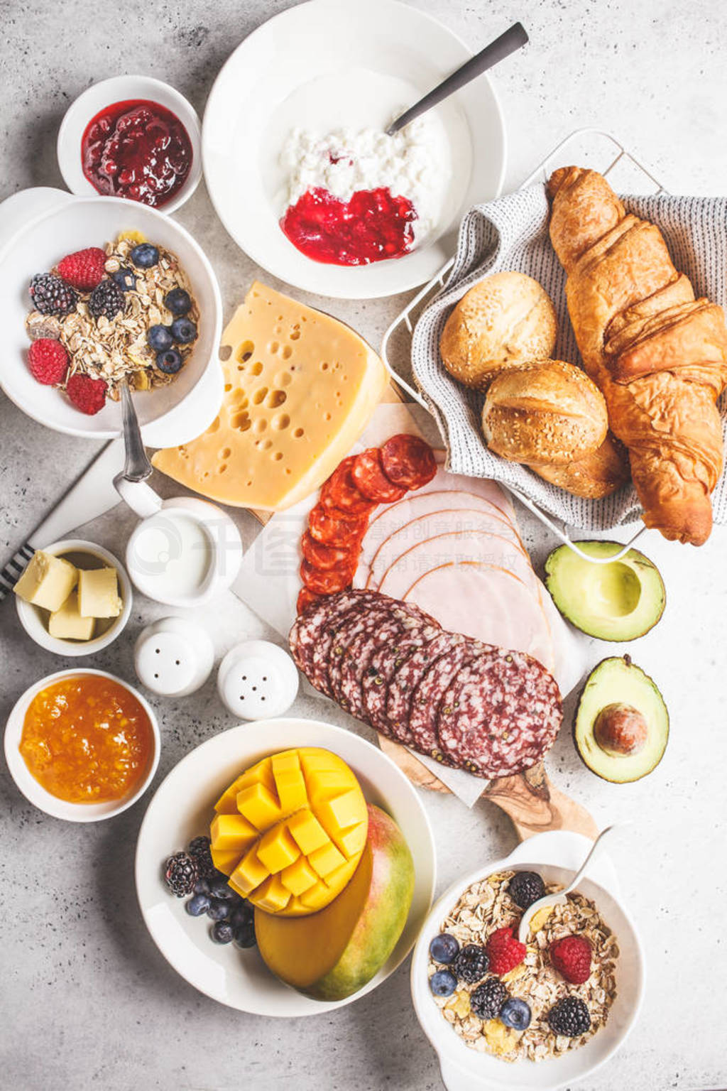 Continental breakfast table with croissants, jam, ham, cheese,