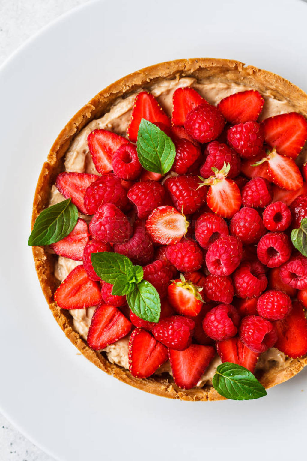 Whole berry tart with raspberries, strawberries and cream