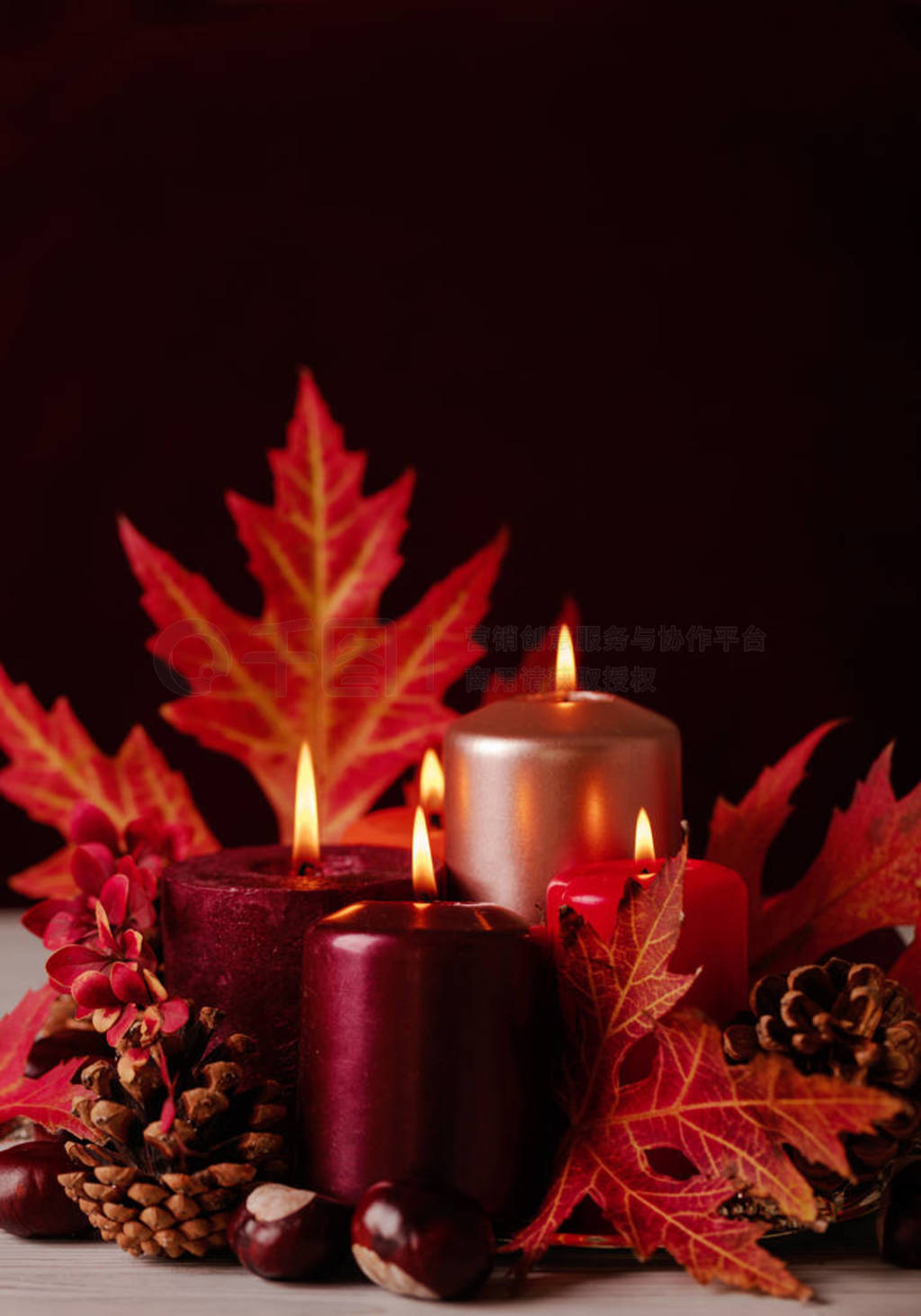 Autumn still life - candles, leaves and cones on the background