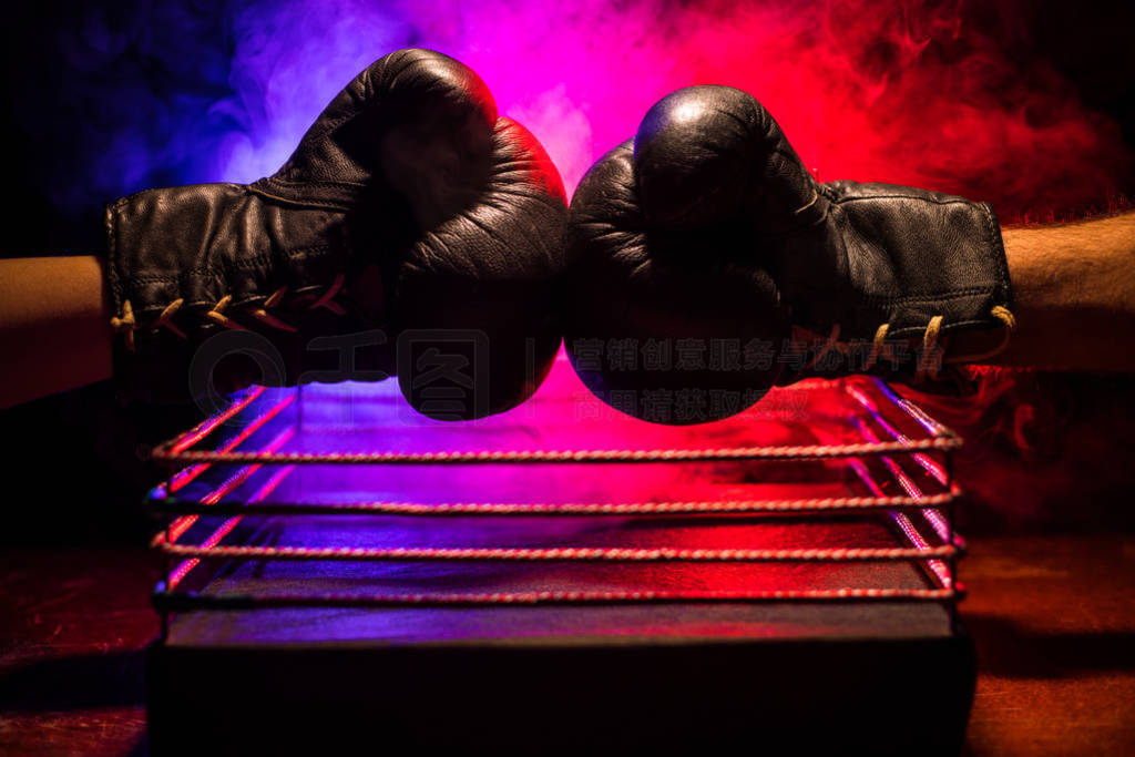 Empty boxing ring with red ropes for match in the stadium arena.