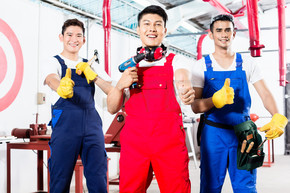 三名亚洲产业工人 一个制造团队 自豪地站在工厂里竖起大拇指
