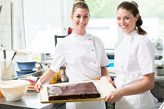 糖果商或糕点制造商在他们的面包店烘<i>烤</i>馅饼和蛋糕