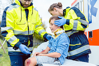 紧急医疗人员照顾鞭打受伤的男孩