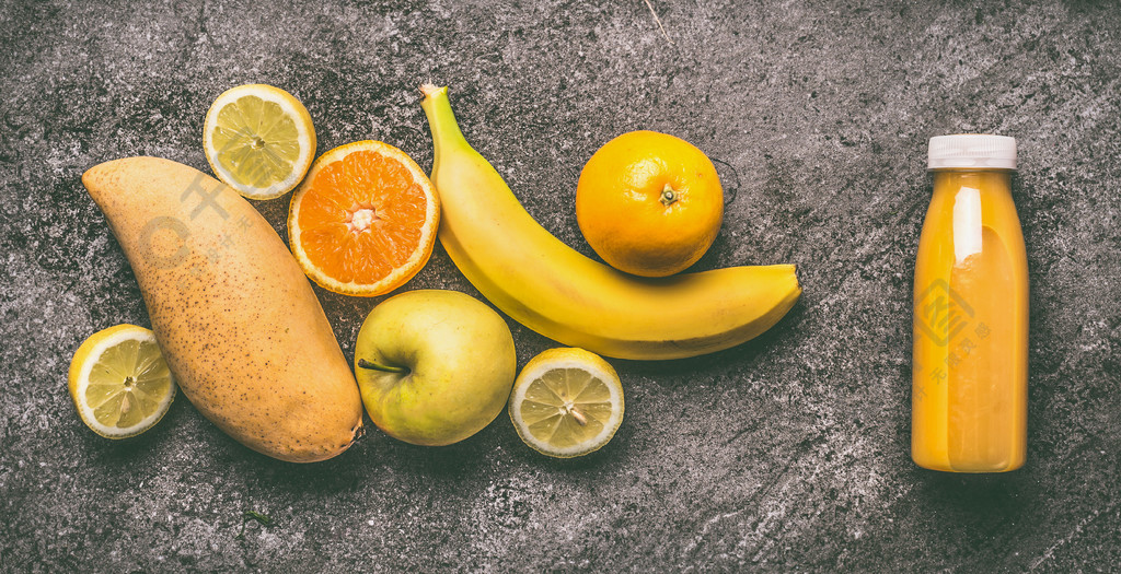 黄色有机果子圆滑的人用柠檬,桔子,苹果,芒果和香蕉在瓶在灰色花岗岩