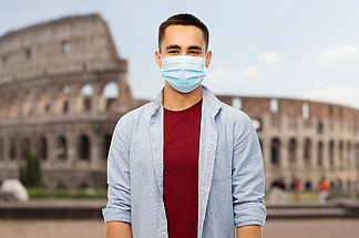 健康，安全和大<i>流</i>行概念-在罗马，意大利背景供以人员戴着保护的防护医疗面具免受在大剧场的病毒疾病在意大利戴防护口罩的男人