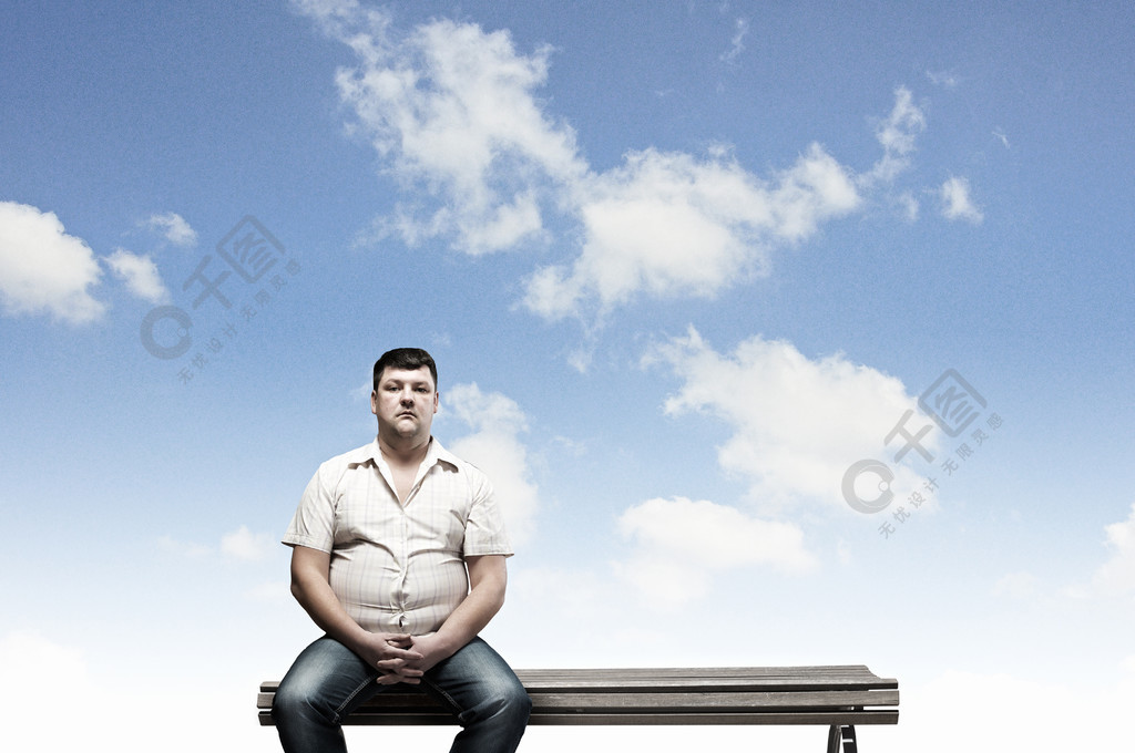 胖子胖男人坐在长椅上看着相机