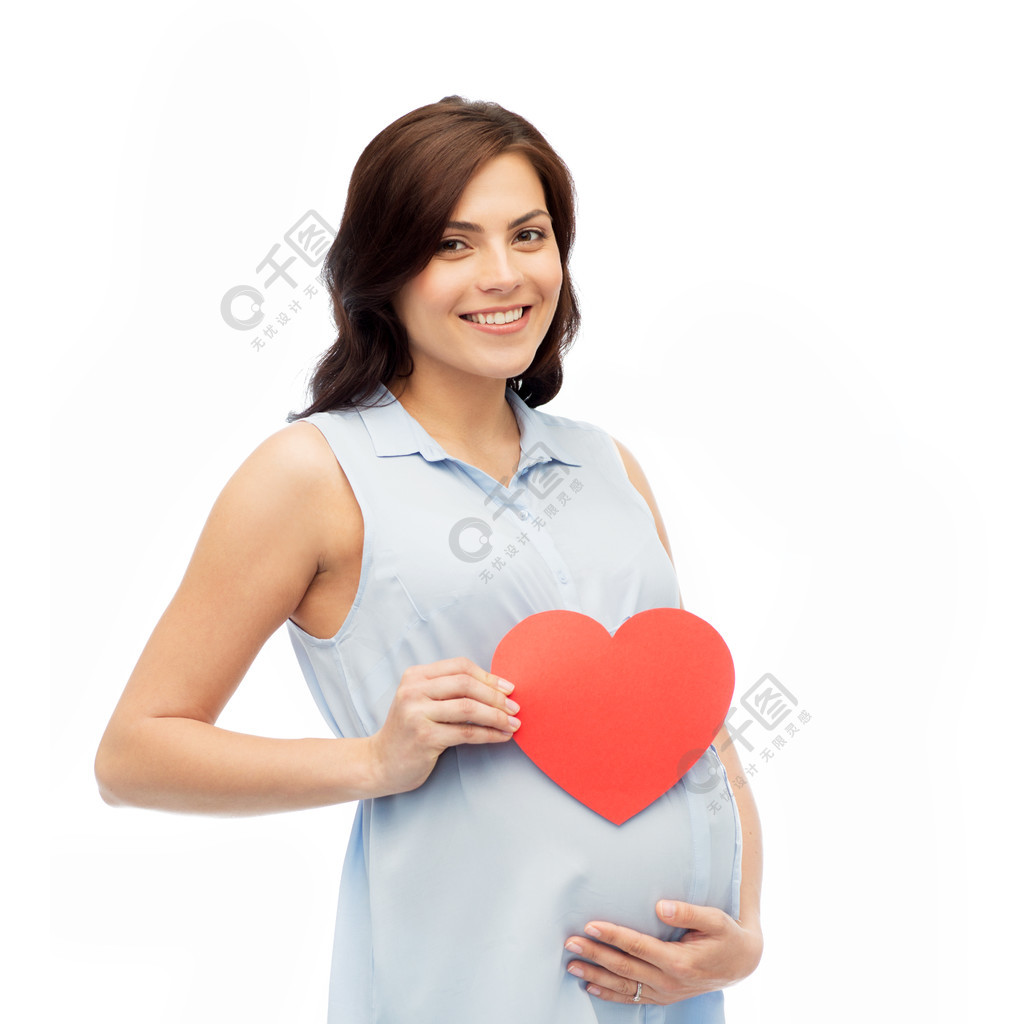 怀孕，爱，人们和期望概念-有红色心脏的愉快的孕妇塑造接触她的在白色背景的腹部