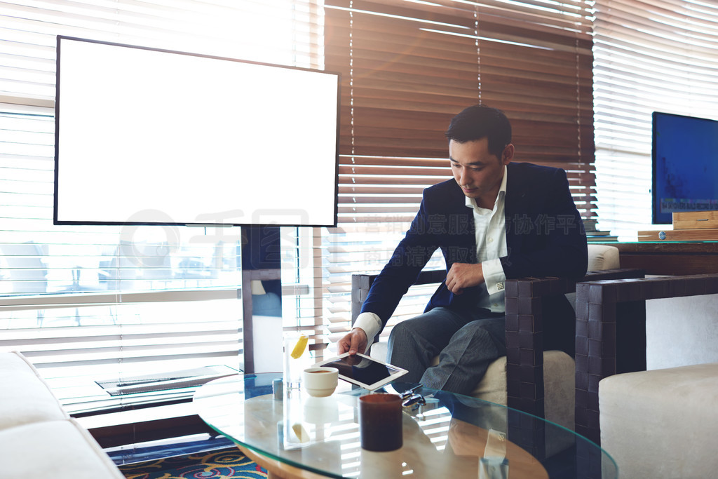 Asian businessman working on touch pad