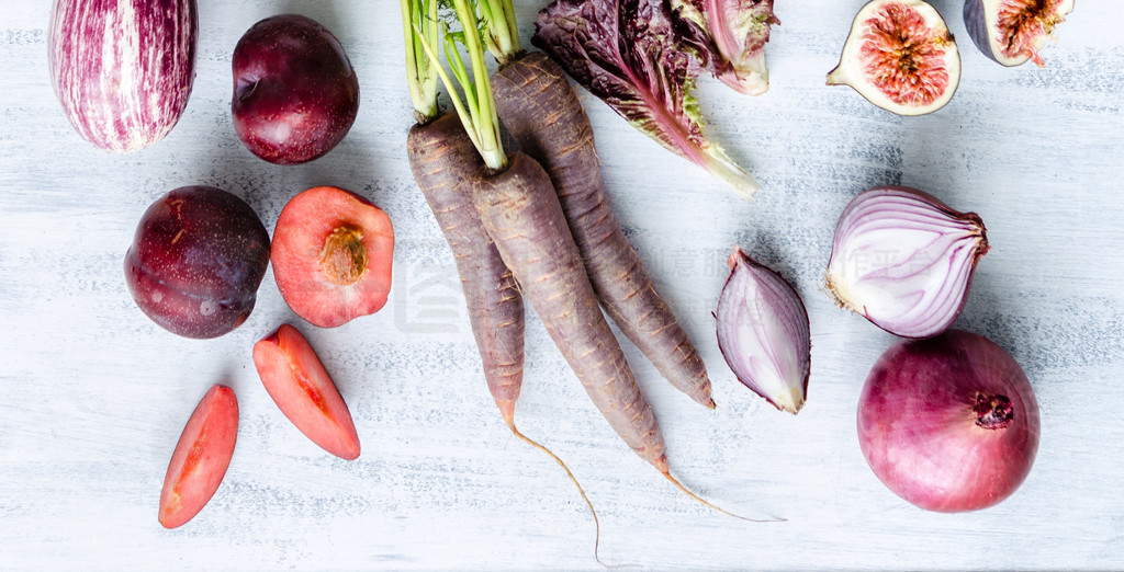 Assorted purple toned fruits and vegetables