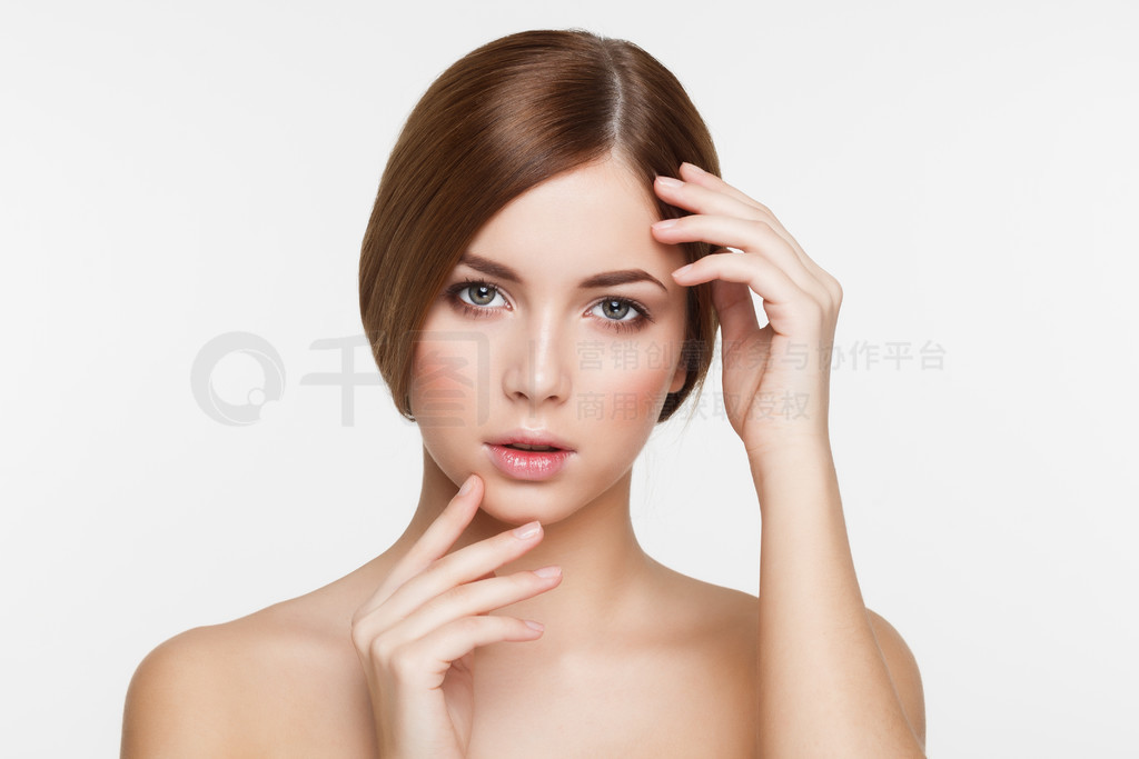 Young beautiful brunette woman with natural makeup on grey background