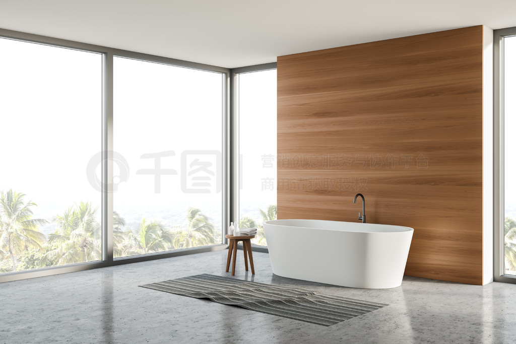 Corner of stylish bathroom with wooden walls, concrete floor and comfortable white bathtub standing