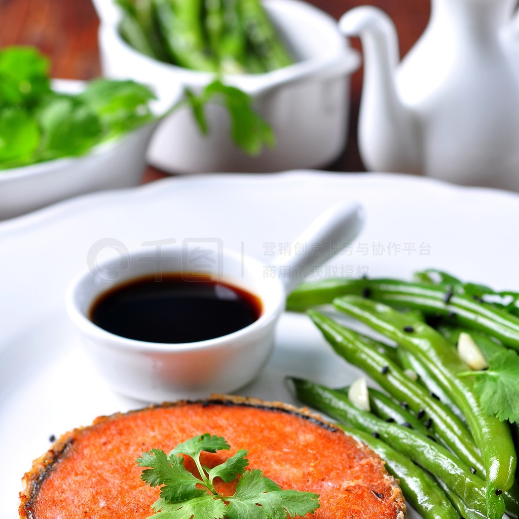 Salmon steak with green beans, garlic, black sesame and soy sauce. Selective focus.