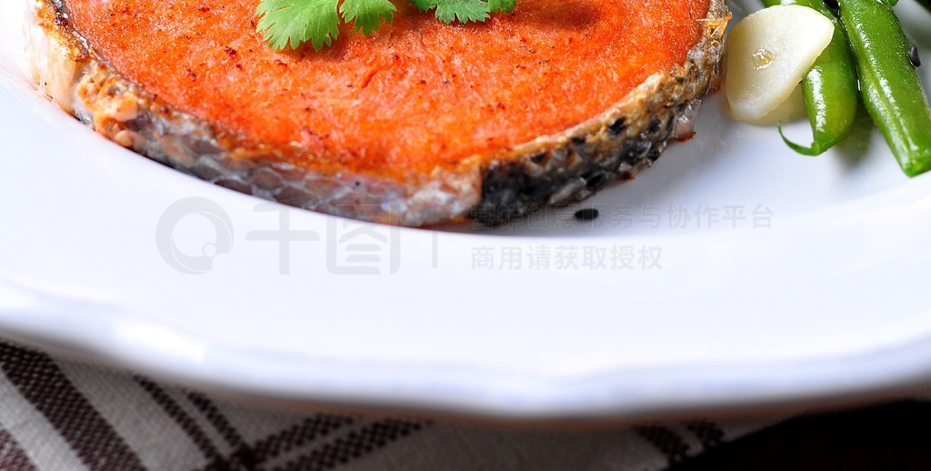 Salmon steak with green beans, garlic, black sesame and soy sauce. Selective focus.